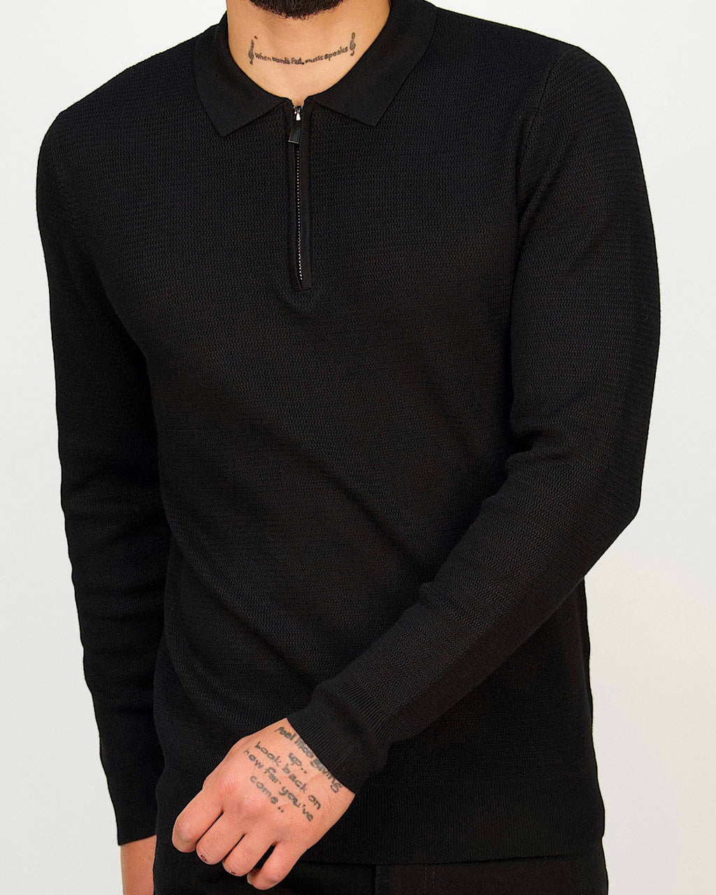 Black fine-knit zip-collar polo, also available in white, green, navy and beige.