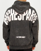 Back view of a men’s oversized washed black hoodie featuring a large Riches Paris back print and “I’M FOUND MONEY” text.