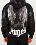 Back view of a men’s oversized black hoodie with illustrated angel wings and lightning-style graphic detailing.