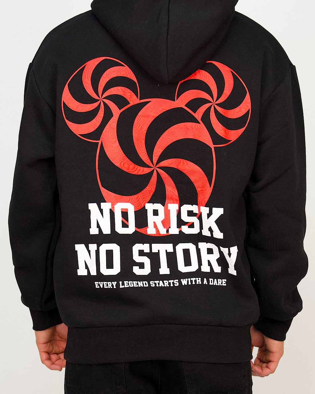 Back view of a men’s oversized black hoodie featuring a bold red spiral graphic and the text “No Risk No Story”.