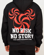 Back view of a men’s oversized black hoodie featuring a bold red spiral graphic and the text “No Risk No Story”.