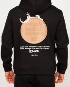 Back view of a men’s regular-fit black hoodie with a large coin-style graphic and layered text.