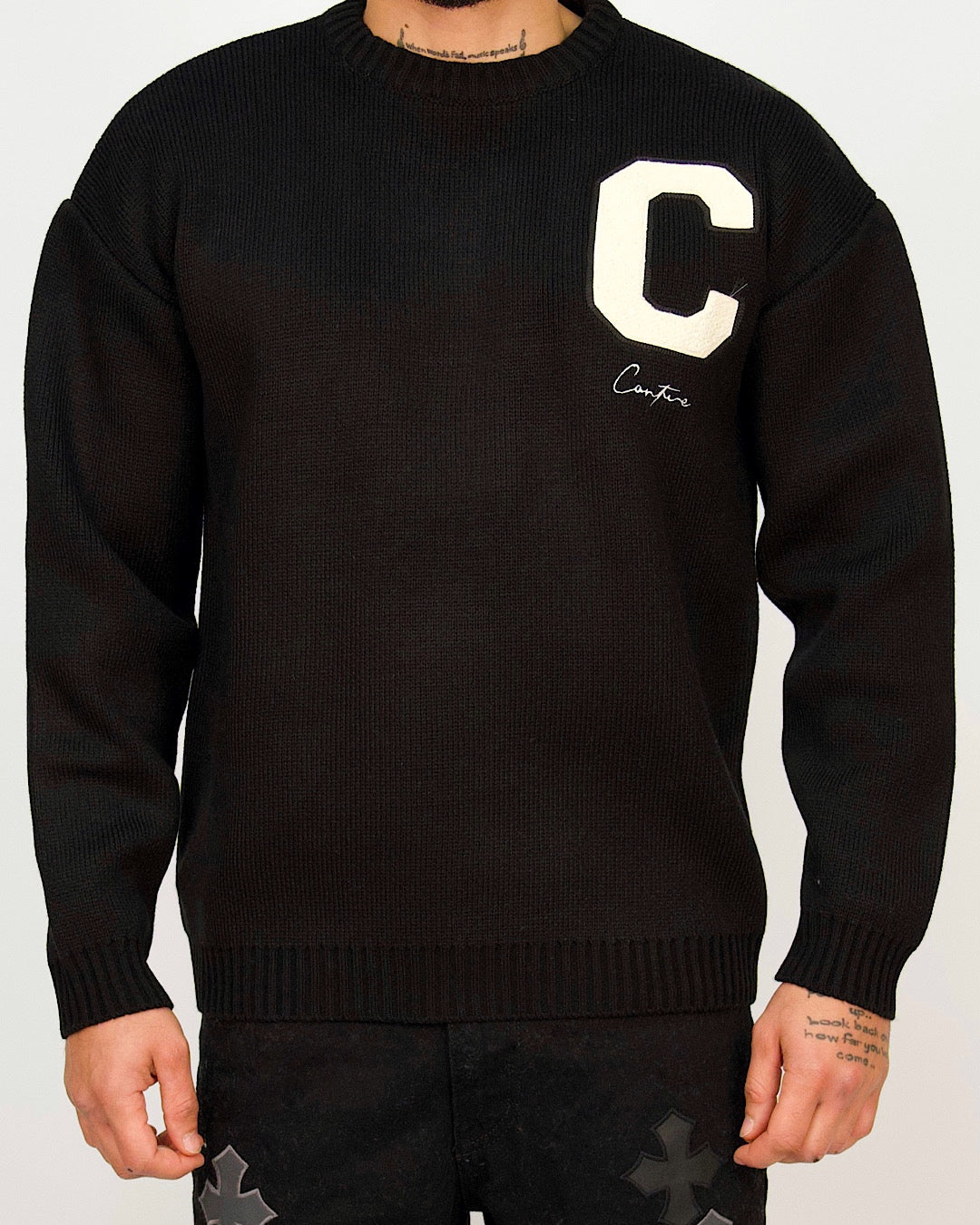 Front view of a men’s regular-fit black knit sweater with a varsity-style “C” chest patch and script embroidery.