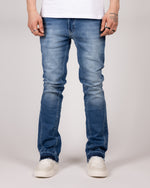 Washed Blue Flared Jeans With Raw Hem And Vintage Fade