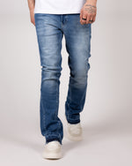 Washed Blue Flared Jeans With Raw Hem And Vintage Fade