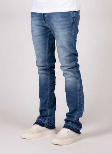 Washed Blue Flared Jeans With Raw Hem And Vintage Fade