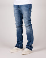 Washed Blue Flared Jeans With Raw Hem And Vintage Fade