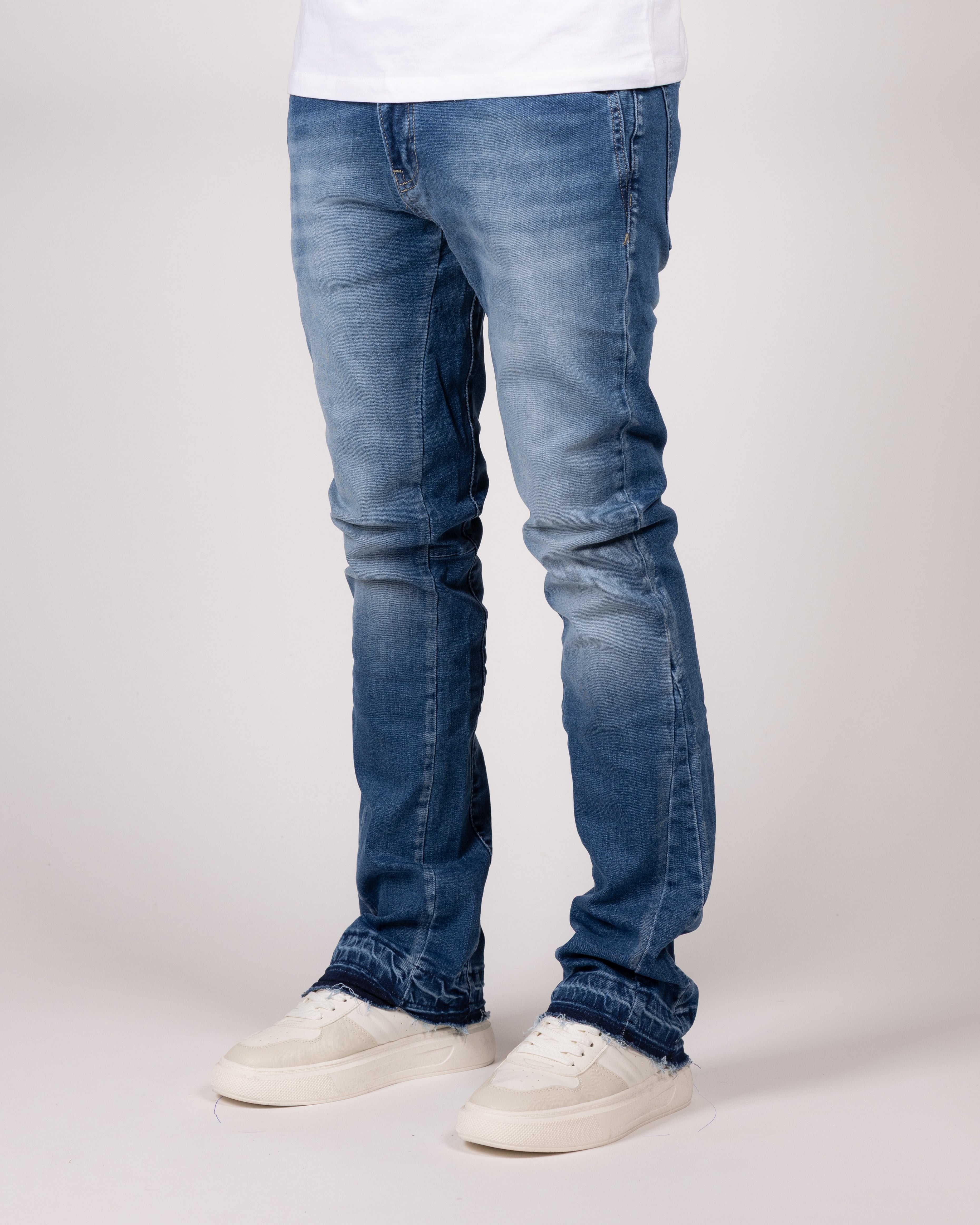 Washed Blue Flared Jeans With Raw Hem And Vintage Fade