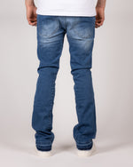 Washed Blue Flared Jeans With Raw Hem And Vintage Fade